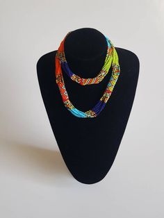 This necklace is 100% handcrafted using colorful fine beads. The necklace makes a perfect gift to loved ones. **Buy multiple items and pay shipping for 1 item only.The rest ships free. Custom orders are welcome. More neckleces here; https://www.etsy.com/shop/TribalTess?ref=seller-platform-mcnav&section_id=21306083 Back to my shop; https://www.etsy.com/shop/TribalTess?ref=seller-platform-mcnav Unique Multicolor Long Beaded Necklace, Handmade Multicolor Long Bead Necklace, Multicolor Long Necklace With Tiny Beads, Long Multicolor Necklace With Tiny Beads, Unique Multicolor Small Beads, Colorful Multi-strand Handmade Necklace, Orange Multi-strand Beaded Necklaces, Handmade Colorful Multi-strand Beaded Necklaces, Colorful Handmade Multi-strand Necklaces