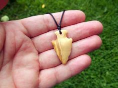 I hand-carved this one-of-a-kind arrowhead pendant from Exotic Italian Olive wood. It's fully carved in the round on both sides so you can hang either way. I like the look of primitive arrowheads so I do my carvings to emulate that style.  A hand rub finish is applied and then the pendant is buffed to a buttery smooth final finish that feels amazing to the touch.  I hung it on a black satin necklace with adjustable sliding knots that allow you to adjust up to any desired length up to approx 35+ Rustic Arrowhead Necklace For Gift, Artisan Arrowhead Necklace For Gift, Brown Arrowhead Necklace For Gift, Rustic Handmade Arrowhead Necklace, Rustic Carved Jewelry As Gift, Satin Necklace, Arrowhead Pendant, Natural Necklace, Minimalist Pendant