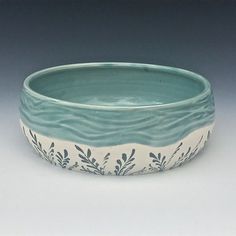 a blue and white bowl sitting on top of a table