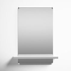 a white shelf with a mirror on it