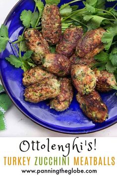 a blue plate topped with meatballs covered in cilantro