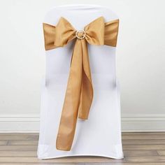 a white chair with gold sashes on it