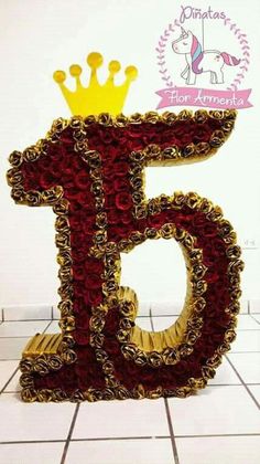 the number five is made out of flowers and has a crown on top of it