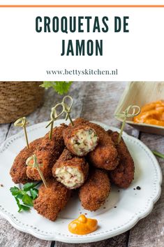 croquettass de jamon on a white plate with orange sauce in the background