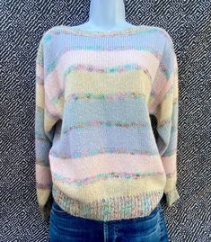 Country Craft women's vintage striped knit sweater, size 40 or medium. Striped pattern in yellow, pink, blue and gray with colorful smaller stripes. In great shape, no stains or major pulls. Adorable sweater with a boat neck and looser fit. Made of 80% acrylic, 12% wool, 7% rayon, 1% nylon. From the 1980's. Measures 23" in length x 18" across chest and sleeves measure 20" Vintage Striped Sweater For Spring, Retro Striped Knitted Sweater, Vintage Striped Cotton Sweater, Multicolor Wool V-neck Sweater, Retro Multicolor V-neck Sweater, Vintage Multicolor Hand-knitted Sweater, Striped Knit Sweater, Pastel Sweater, Country Crafts