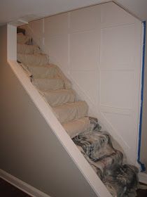 a dog is laying down on the carpeted stairs in front of an open door