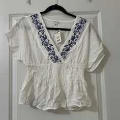 Super Cute Flowy And Breathable Shirt! Never Worn! Casual Blue Embroidered V-neck Top, Casual White Top With Floral Embroidery, Casual Blue Embroidered Short Sleeve Top, Blue Casual Embroidered V-neck Top, Casual Blue Embroidered Tops, Casual V-neck Shirt With Floral Embroidery, Blue V-neck Top With Floral Embroidery, White V-neck Top With Floral Embroidery, Blue Casual Embroidered Top For Vacation