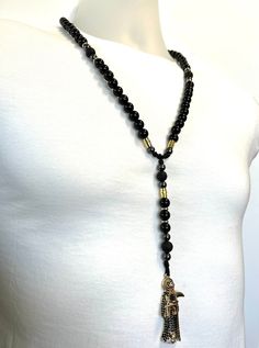 Black Santa Muerte Rosary Black natural Obsidian and Lava rock - Etsy Ecuador Black Hematite Jewelry For Meditation, Black Hematite Spiritual Jewelry, Black Natural Stones Jewelry For Meditation, Black Spiritual Jewelry With Natural Stones, Black 8mm Beads Jewelry For Festival, Black Gemstone Beads Jewelry For Festival, Black Santa, Lava Rock, Beaded Necklaces