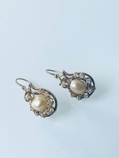 A lovely pair of antique C 1880 late Victorian earrings in black enameled 18K yellow gold highlighted by cushion cut diamonds and centered with 2 certified natural saltwater baroque pearls. The natural saltwater pearls are very rare to find nowadays and these ones are in a very good condition, with high lustre and good skins. The earrings measure 1.3 x 3 cm, weigh 6.7 grams, there are 16 antique cushion cut diamonds at approx. 1 ct total weight, the gold ear wires are later added. Victorian Style Hallmarked Earrings For Formal Occasions, Formal Victorian Hallmarked Earrings, Antique Yellow Gold Wedding Earrings, Antique Yellow Gold Earrings For Wedding, Antique Yellow Gold Earrings For Formal Events, Antique Yellow Gold Earrings For Formal Occasions, Victorian Oval Filigree Earrings, Victorian Filigree Oval Earrings, Luxury Oval Jewelry For Opera