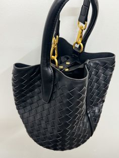 Introducing our Woven Bucket Bag, the perfect combination of luxury and practicality in one. Handcrafted with intricately woven details, this bag is not only visually stunning but also durable. Carry all your essentials in style with this exclusive piece, designed for the modern, sophisticated individual. Fabrication: Vegan Leather Measurements: 6.5" x 7" Athleisure Accessories, Hair Necklace, Shoe Gifts, Branded Gifts, Hat Hairstyles, Bucket Bag, Sweater Outfits, Vegan Leather, Jumpsuit Dress