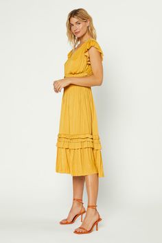 Our most popular dress is back in this classic marigold color. Allover pleating, fluttery cap sleeves, and sweet ruffle accents deliver a decidedly feminine look to this V-neck midi dress. Relaxed fit, size down for slimmer fit •Irregular pleating •V-neck •Cap sleeves •Allover pleating •Ruffle trim •Midi length DIMENSI Popular Dress, Marigold Color, Popular Dresses, V Neck Midi Dress, Pleated Midi Dress, Feminine Look, Ruffle Trim, Ruffle Hem, Lifestyle Brands