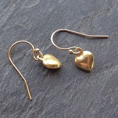 Sweet vermeil puffed gold heart charm earrings add just that little bit of dainty elegance to your ears.  They're a gorgeous buttery gold color and..... exquisite and perfectly formed.    Vermeil is a thick coating of carat gold on solid sterling silver. These petite hearts hang from top quality elegant ball ended 14kt gold fill earwires, they're light and easy to wear for everyday.  A symbol of love always makes the perfect gift! Matching necklace - https://etsy.me/2DiboCB* Length drop about 2c Classic Gold Heart Earrings For Anniversary, Gold Heart-shaped Earrings As Gift For Her, Gold Heart Earrings As A Gift For Her, Gold Heart Earrings Gift For Her, Gold Heart-shaped Earrings For Her, Gold Minimalist Heart Earrings For Everyday, Dainty Gold Earrings Gift For Her, Gold-plated Heart Earrings For Everyday Wear, Gold Heart Drop Earrings For Her