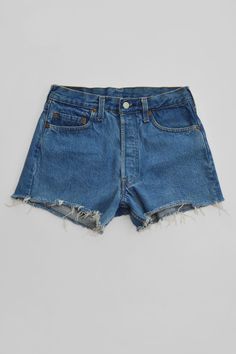 A classic pair of vintage Levi Strauss & Co red tab cut-off denim shorts in a perfect faded retro blue. This pair is in good condition except unfortunately, the red tab at the back pocket has been cut off and there are small burgundy dot marks at the interior of body (not visible on the exterior and only in a small area towards the bottom cut edge). The back denim patch has been stamped with "irregular" but the 5 button fly jean shorts fit great. Details: Vintage denim cut-off shorts (good condi Vintage Blue Cutoff Jean Shorts, Vintage High Rise Denim Blue Shorts, Vintage Denim Shorts In Medium Wash, Retro Medium Wash High-waisted Jean Shorts, Vintage Medium Wash Denim Shorts, Vintage High-waisted Medium Wash Jean Shorts, Retro High-waisted Jean Shorts In Medium Wash, Vintage High-waisted Shorts Jeans In Medium Wash, Vintage High-waisted Medium Wash Shorts