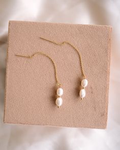 Add a touch of whimsy to any outfit with our brand new Phoebe Pearl Threaders! These delicate earrings feature a playful threader design that effortlessly loops through your ear for a unique & minimalist look. Adorned with freshwater pearls, they're sure to elevate any outfit! EARRINGS FEATURE Material: 14K Gold Filled or Sterling Silver threader Freshwater pearls Hand wire-wrapped with 14K gold filled or Sterling Silver wire Hypoallergenic & great for sensitive skin Minimalist Pearl Drop Threader Earrings, Elegant Threader Earrings With Delicate Chain, Dainty Linear Earrings With Pearl Charm For Gift, Minimalist Pearl Threader Earrings As Gift, Everyday Pearl Drop Threader Earrings, Everyday White Pearl Drop Threader Earrings, White Pearl Threader Earrings With Charm, Delicate 14k Gold-filled Threader Earrings, White Minimalist Dangle Threader Earrings