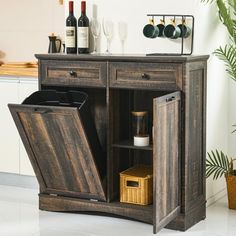 an open cabinet with wine bottles and glasses in it next to a potted plant