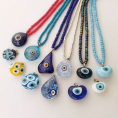 Evil Eye Beaded Necklaces As Gift, Evil Eye Beaded Necklaces With Round Beads As Gift, Blue Evil Eye Necklace With Round Beads, Blue Evil Eye Pendant Necklace, Turquoise Evil Eye Amulet Necklace, Spiritual Blue Evil Eye Charm Necklace, Blue Evil Eye Beaded Necklaces, Handmade Blue Evil Eye Bracelet, Bohemian Blue Beaded Necklaces With Evil Eye