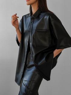 Chic minimal loose fit leather half sleeve shirt. Perfectly mimics lambskin with high quality PU. Fabric contains natural stretch. Inside of the shirt is lined with suede for warmth and softness. Model is in MINUSEY ONE SIZE. ✔️ Free worldwide express shipping over $100✔️ Loved by 6,500+ customers✔️ Limited edition collections, maximum style⠀⠀⠀⠀⠀⠀⠀⠀⠀Stay ahead of the trend with can’t-find-anywhere-else staples. Your closet will thank you 💕 * MINUSEY ONE SIZE = EU 34-38, US 2-6* 100% PU Leather* Dry clean* Made in Korea - Model Height: 169cm/5'6" (US2, EU34) Short Sleeve Leather Shirt Outfit, Faux Leather Button Down Shirt Outfit, Leather Shirt Outfit Black Women, Leather Button Down Shirt Outfit, Black Leather Collared Top, Black Short Sleeve Leather Top, Black Leather Short Sleeve Top, Black Oversized Short Sleeve Outerwear, Oversized Black Outerwear With Short Sleeves