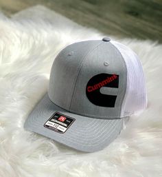 Listing is for a customizable trucker hat. There is a discount if you are purchasing 12 or more hats. If you need quantities over 100 message me for a price quote. Pricing includes digitizing your logo, and the embroidery on the hat. Turn around time can vary depending on current work load but will be between 1-3 weeks. Hat colors are listed, leave your hat color choices in the notes at check out. I will need a high resolution image sent after purchasing the hat. Once it has digitized I will sen White Cotton Trucker Snapback Hat, Custom Logo Cotton Trucker Hat With Flat Bill, Cotton Trucker Hat With Custom Logo And Flat Bill, Custom Logo Cotton Snapback Trucker Hat, White Trucker Hat With Custom Logo And Curved Bill, Trucker Snapback Hat With Embroidered Logo, Trucker Hat With Embroidered Logo, White Curved Bill Trucker Hat With Custom Logo, White Trucker Hat With Custom Logo