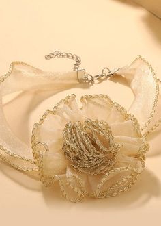 This elegant choker features a stunning 3D flower design, made with delicate organza material and finished with intricate edging. Adding a touch of femininity to any outfit, the beige color complements any skin tone. Perfect for both formal and casual occasions. *Return & Exchange are not supported Chic Cream Jewelry For Party, Summer Party Flower Shaped Choker, Adjustable Chic Wedding Choker, Chic Adjustable Wedding Choker, Chic Spring Party Choker, Chic Beige Jewelry For Spring, Chic Summer Party Choker, Elegant Flower Decorated Choker, Elegant Flower Choker For Party