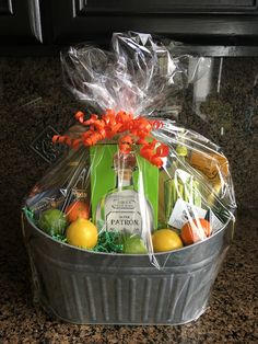 a gift basket with oranges, lemons, and bottles of alcohol in it