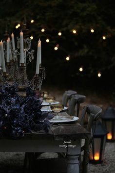 a table with candles and plates on it