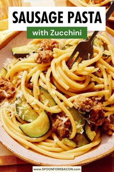 sausage pasta with zucchini in a white bowl