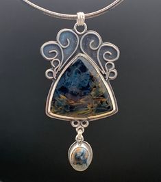 "This necklace is part of my Twigs and Succulents Line. This necklace is made up of natural gorgeous Pietersite set in fine silver and sterling.   The pendant is 3\" long by 1.25\" wide. The chain is 18\" long. More info about Pietersite: Pietersite is a trade name for a dark blue-grey breccia aggregate made up mainly of hawk's eye and tigereye. It is a variety of chalcedony (itself a variety of quartz) with embedded fibers of amphibole minerals in varying degrees of alteration. The fibers cause Jewelry Sketching, Silversmithing Jewelry, Pearl Cluster Necklace, Silver Clay, Rainbow Moonstone Necklace, Metalsmithing Jewelry, Rainbow Moonstone Pendant, Resin Ideas, Witchy Woman