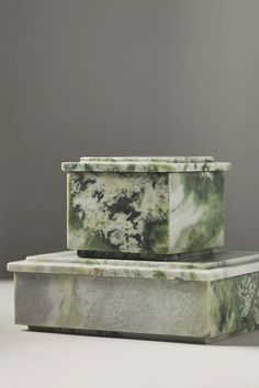 two marble boxes sitting on top of each other