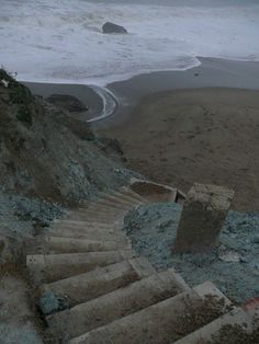 the stairs lead down to the beach and into the ocean on a foggy day