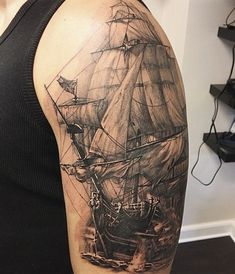 a black and white photo of a ship on the back of a man's arm