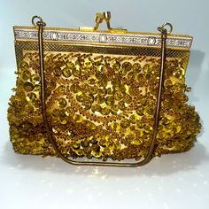 Vintage Delill Evening Bag In Excellent Unused Condition, Like New. No Damage Or Signs Of Use Or Wear. The Interior Liner Is Free From Any Flaws - There Are No Stains Or Discoloration. It Is Truly Flawless And Exceptional For Its Age. The Bag Is Hand Beaded With Gold Glass Beads And Sequins. It Has White And Gold Ornate Detailing Across The Top And A Metal Chain Top Handle. The Interior Is Lined With A Light Colored Satin Fabric. Width: 7.5” Height: 5” Offers & Bundles Welcome! Discounts!!! **** Elegant Chain Evening Bag As Gift, Elegant Handheld Evening Bag With Chain, Elegant Gold Shoulder Bag With Chain, Gold Clutch Bag With Chain, Gold Chain Clutch Shoulder Bag, Gold Shoulder Bag With Chain For Party, Elegant Gold Evening Bag With Chain, Luxury Gold Beaded Evening Bag, Gold Rectangular Shoulder Bag With Chain