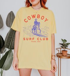 Cowboy Surf Club Coastal Cowgirl Summer Tshirt Beach Tee Western Graphic Tee Cute Country Shirt Oversized Short Sleeve Comfort Colors Tee All items are made to order. Items will ship within one week from my printing partner. Please allow time for production and shipping! If you have any issues or concerns please reach out via Etsy messages so I can help!  If you feel you received a defective/misprinted item please let me know within 30 days of receiving your order, I'm happy to work with you to find a resolution! For cancellation requests please reach out within an hour of placing your order! Comfort Colors introduces the "Comfort Colors 1717" garment-dyed t-shirt; a fully customizable tee made 100% with ring-spun cotton. The soft-washed, garment-dyed fabric brings extra coziness to your w Cowgirl Summer, Cute Country, Surf Club, Summer Tshirt, Western Graphic Tees, Beach Tee, Cute N Country, Country Shirts, Coastal Cowgirl