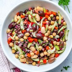 a white bowl filled with beans and veggies