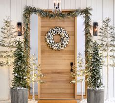 a wooden door decorated with wreaths and christmas trees