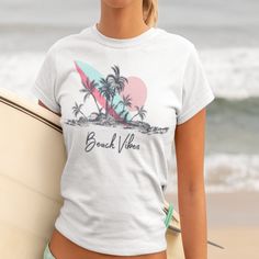 Get into the summer spirit with our Beach Vibes T-shirt featuring a stunning image of a beach, palm trees, and a surfboard. This graphic tee is perfect for those who love the ocean and all things beach-related. Made from high-quality materials, this t-shirt is comfortable to wear and will quickly become a favorite in your wardrobe. Whether you're planning a trip to the coast or just want to bring some beach vibes into your daily life, this shirt is the perfect choice. Makes a great gift for beach lovers and anyone who enjoys a touch of tropical paradise in their outfits. Order yours today and let the summer vibes wash over you! .: 100% Airlume combed and ringspun cotton (fiber content may vary for different colors) .: Light fabric (4.2 oz/yd² (142 g/m .: Retail fit .: Tear away label .: Ru White Tropical T-shirt For Beach Season, White Tropical Print T-shirt For Vacation, Tropical Print T-shirt For Vacation, White Tropical Print T-shirt For Summer, Beach T-shirt With Sublimation Print, Tropical Graphic Print T-shirt For Beach, Tropical Print T-shirt For Beach, Tropical Graphic Print T-shirt For Vacation, White Beachy T-shirt For Beach Party