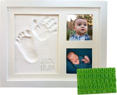 a baby's hand and foot prints are displayed in a white frame next to a green rubber stamp