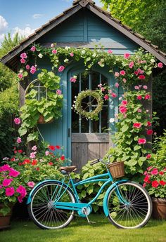 a blue bicycle parked in front of a house with flowers growing on the walls and around it