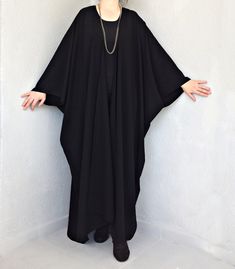 "This black long kimono is perfect for so many occasions! It is an oversized maxi poncho is made of soft flowy cotton blend fabric. You can use this kimono dressing gown every day both indoors or outdoors. The summer kimono cardigan is very loose, and it suitable for all body forms and shapes. Also, it can wear as a boho beach cover-up in summer. You will look fabulous when you wear this summer poncho top. This long cloak would be a perfect gift for you or your loved ones. The plus-size kimono r Oversized Long Sleeve Black Abaya, Oversized Black Long Sleeve Abaya, Oversized Black Abaya, Black Oversized Long Abaya, Oversized Black Long Abaya, Black Oversized Bohemian Cape, Oversized Long Sleeve Abaya For The Beach, Black Maxi Length Abaya For Beach, Elegant Oversized Black Cape