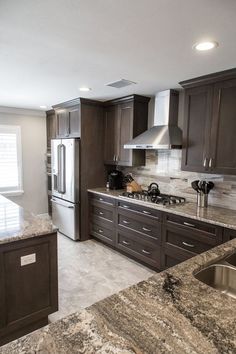 a kitchen with granite counter tops and stainless steel appliances