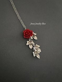 Beautiful red resin rose with dangling silver leaves. Detailed stainless steel leaves measure 15.5mm x 11mm. Total pendant length with rose and leaves is just over 2 inches. This necklace is 18'' long with lobster clasp. *15mm Resin rose *Stainless steel chain *Stainless steel leaves *Handmade with love <3 Like Jmesjewelrybox on Facebook for updates on new jewelry, upcoming sales and giveaways! Plus Facebook fans save 5% :D Find the coupon code on Jmesjewelrybox's cover photo https://www.face Rose Colored Dangle Jewelry With Rose Design, Valentine's Day Dangle Jewelry With Rose Design, Red Flower Pendant Jewelry With Rose Design, Red Rose Design Flower Pendant Jewelry, Luxury Red Rose Design Flower Pendant Jewelry, Red Dangle Jewelry With Rose Design, Red Rose Design Dangle Jewelry, Rose Branch, Resin Rose