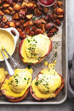 an image of eggs benedict with potatoes on a baking sheet ready to be served in the oven