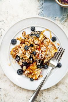 a white plate topped with french toast and blueberries