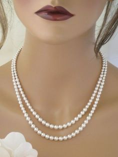 This simple and elegant pearl necklace features 2 graduated strands with pearl sizes from 4mm to 6mm. A sterling silver chain and lobster clasp complete this fine pearl necklace. The perfect finishing touch to your classic or vintage wedding! Double Strand Pearl Necklace For Formal Occasions, Formal Double Strand Pearl Necklace With Pendant, Formal Double Strand Pearl Necklace, Classic Double Strand Pearl Pendant Necklace, Classic Double Strand Pearl Necklace With Pendant, Elegant Double Strand Necklace For Anniversary, Classic Double Strand Pearl White Necklace, Elegant Double Strand Pearl Necklace With Charm, Elegant Double Strand Silver Pearl Necklace