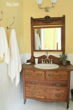 a bathroom with a sink, mirror and towel rack