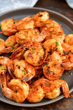 grilled shrimp on a plate with parsley