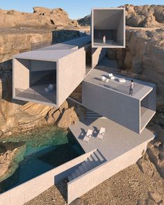 an aerial view of two houses on the cliff