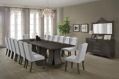 a dining room table with white chairs around it