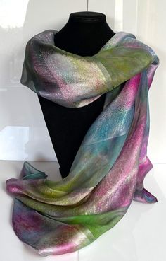 This hand painted silk scarf is made from luxurious silk jacquard. With alternating panels of silk organza and woven jacquard, this large oblong scarf has a striking sheen and is suitable for evening or day wear. Painted by Acacia Silks Tasmania, this unique scarf is impossible to replicate. The dyes used to paint this scarf have been fixed and the easy-care instructions are supplied with the item. Unique Scarf, Hand Painted Silk Scarf, Painted Silk, Hand Painted Silk, Silk Organza, Silk Scarf, Scarf Wrap, Labour Day, Scarf Accessory