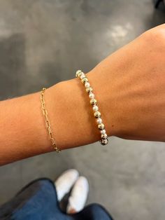 This bracelet is a classic gold beaded bracelet with alternating bead sizes. The larger bead size is a 6mm and the smaller bead size is a 4mm. Made with 4mm pearls and 6mm 14kt gold-filled beads Worry-free wear‚ which means sleep, shower and sweat in it Hand beaded on high performance elastic for a slight stretch to easily roll on and off your wrist Measures 7.25" Classic Beaded Bracelets With Round Beads For Everyday, Gold Hand-strung Pearl Bracelet For Everyday, Everyday Gold Hand-strung Pearl Bracelet, Classic Beaded Bracelets For Everyday, Classic Everyday Beaded Bracelets, Adjustable Yellow Gold Beaded Bracelet With Pearl Chain, Gold Pearl Bracelet With Spacer Beads For Everyday, Pearl Beaded Bracelets With 8mm Beads, Classic Everyday Beaded Bracelets With 8mm Beads