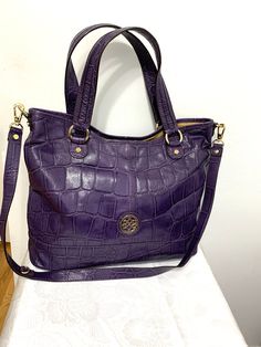 this is a lovely Antonio Melani embossed purple leather large bag purse shoulder bag.' Main compartment with a snap closure the inside has a wall zippered pocket 2 slip pockets and a padded mid section zippered pocket . Measures app 17"x14"x5"  shoulder strap is 20"drop. Condition is excellent . Comes from a smoke free home. Purple Shoulder Bag With Zipper For Daily Use, Purple Leather Rectangular Bag, Purple Rectangular Shoulder Bag With Zipper, Luxury Purple Tote Shoulder Bag, Everyday Purple Shoulder Bag With Zipper, Purple Leather Tote Shoulder Bag, Purple Leather Shoulder Bag With Adjustable Strap, Everyday Purple Leather Shoulder Bag, Purple Leather Shoulder Bag For Everyday